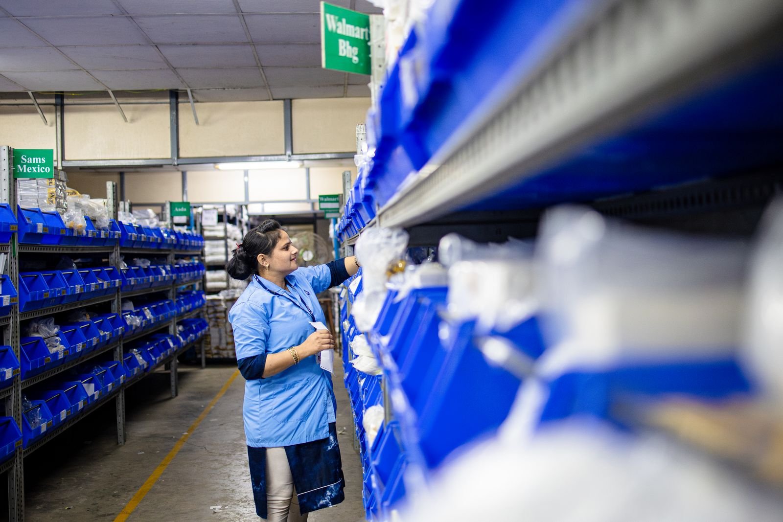 Warehouse operative picking stock from racking
