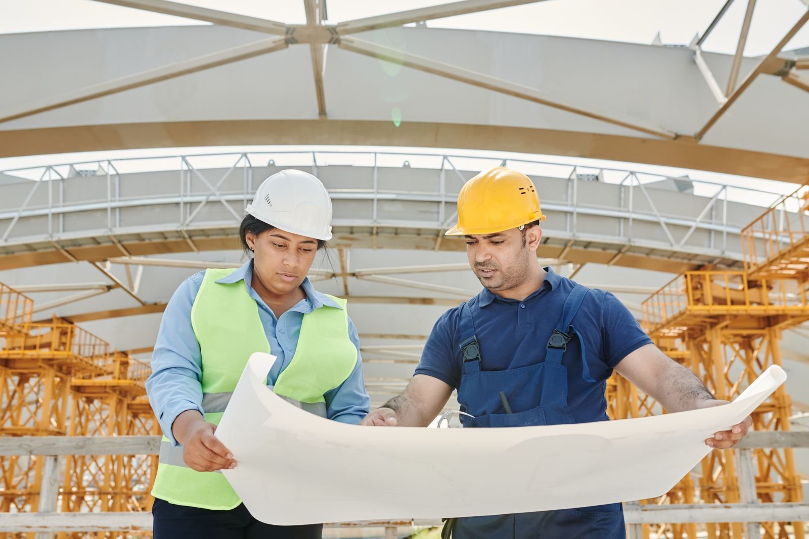 Engineers reviewing drawings on a construction site